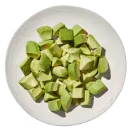 Avocado from Cava menu – creamy, ripe avocado served as a fresh topping or side with Mediterranean dishes.