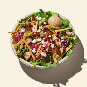 Tahini Caesar Bowl with crisp greens, creamy tahini dressing, and crunchy toppings.